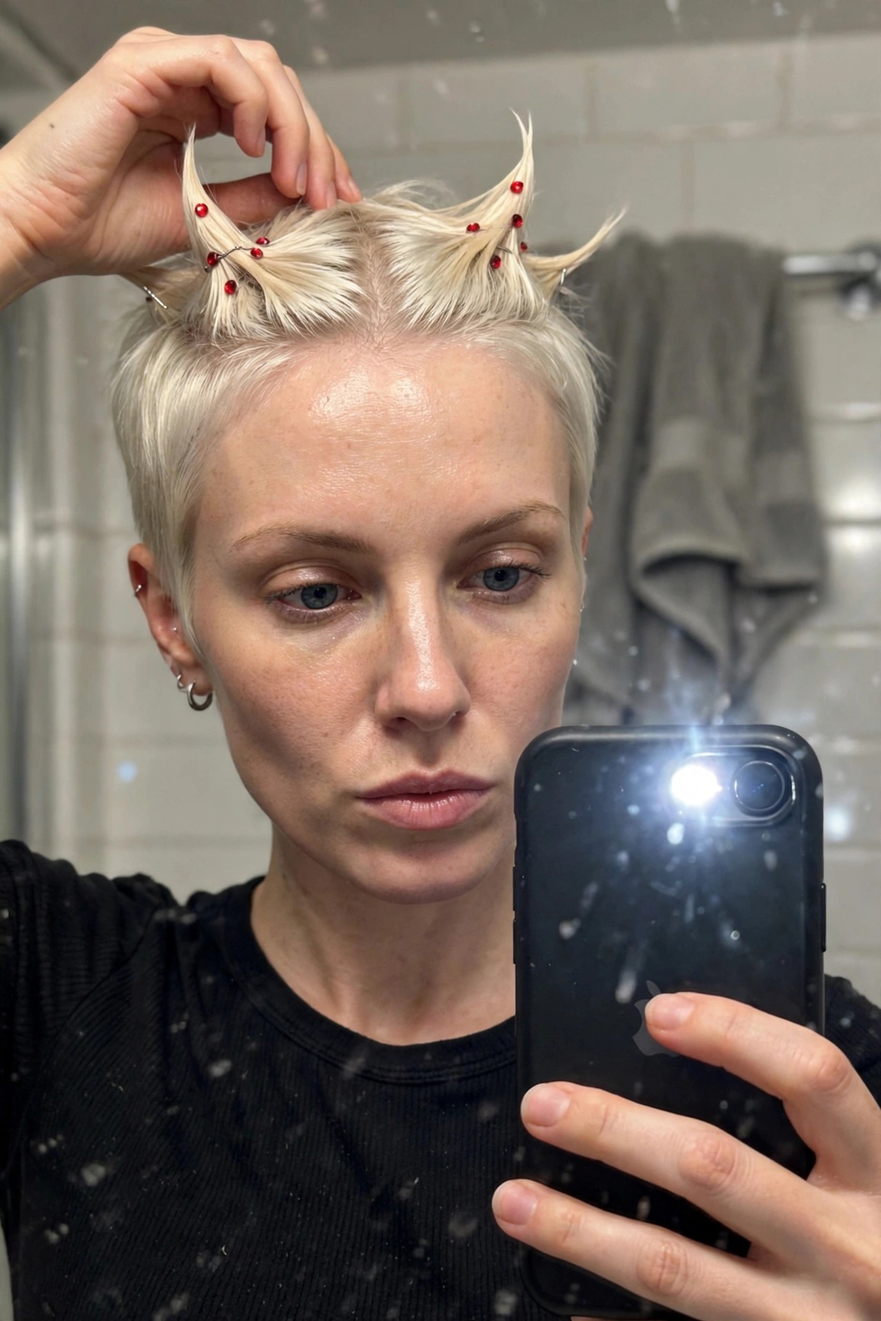short platinum pixie with two small hair sections lifted into horns and secured with red gems and silver wires