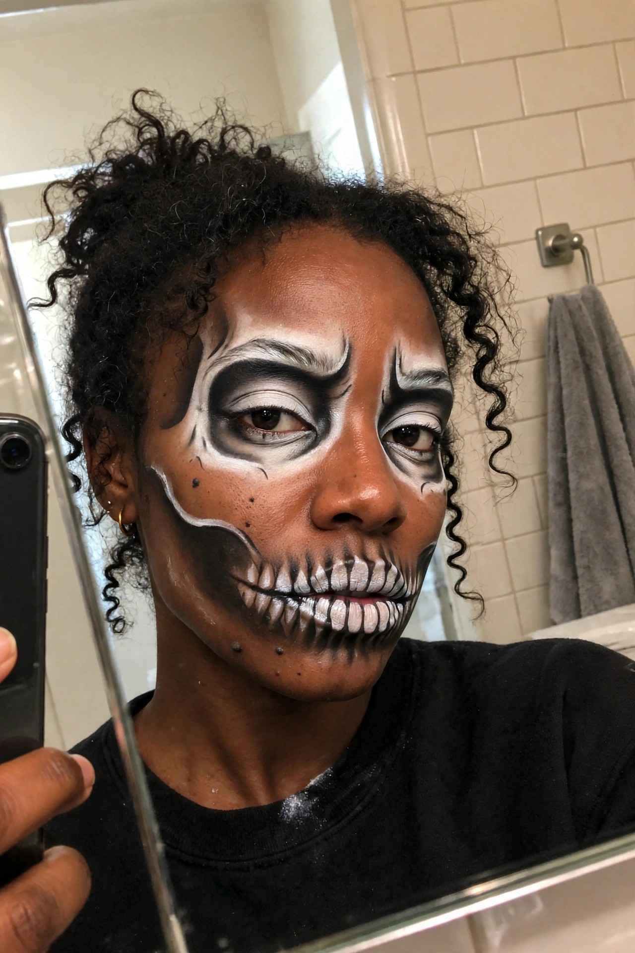 Close up of skeleton skull face paint with white and black shading around the eyes and teeth details painted over the mouth.